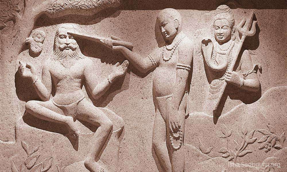 Inside isha dhyanalinga temple: Stone panel depicting Sadhguru enlightenment story.